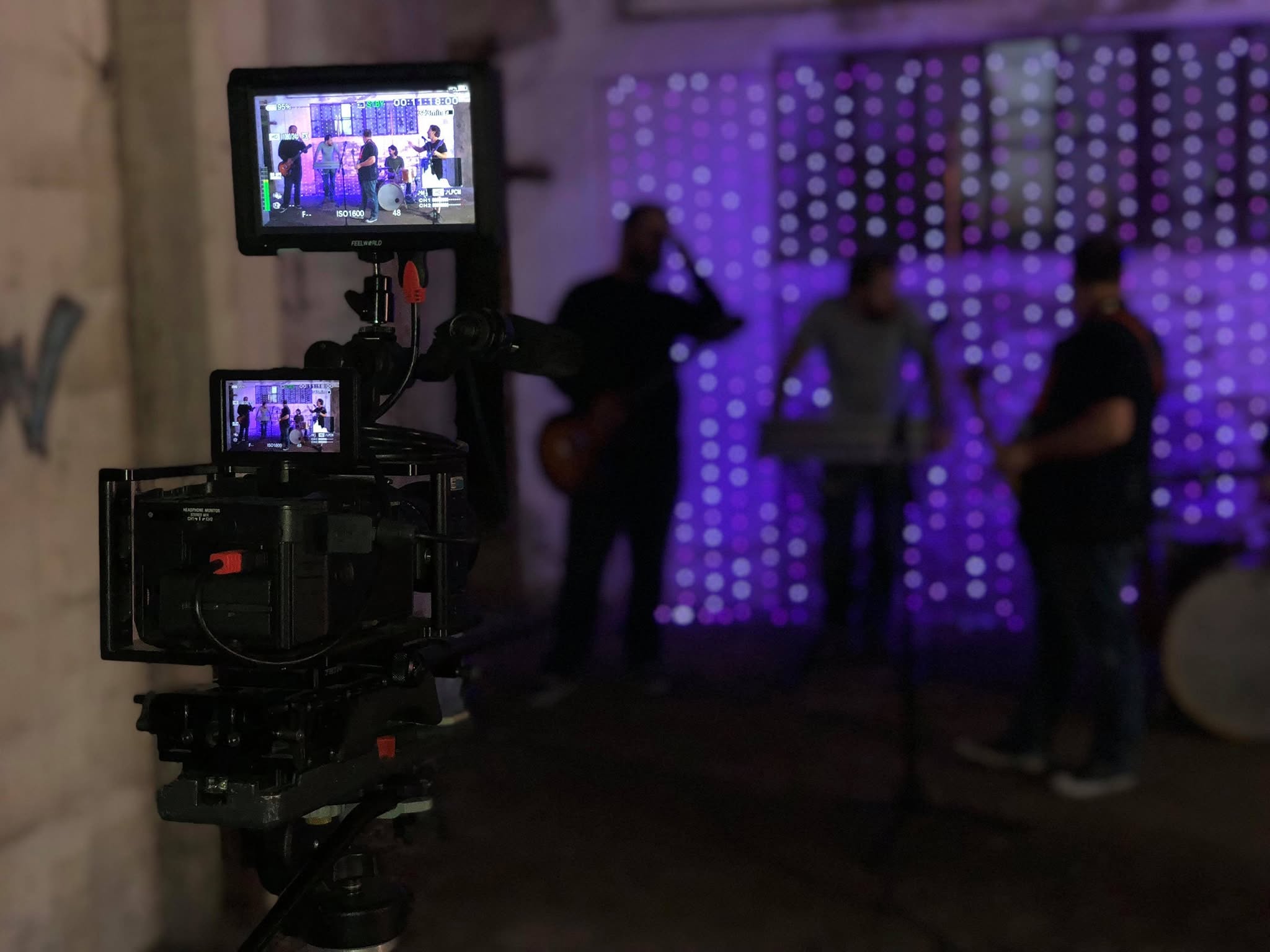 Cinema camera on a purple-lit set