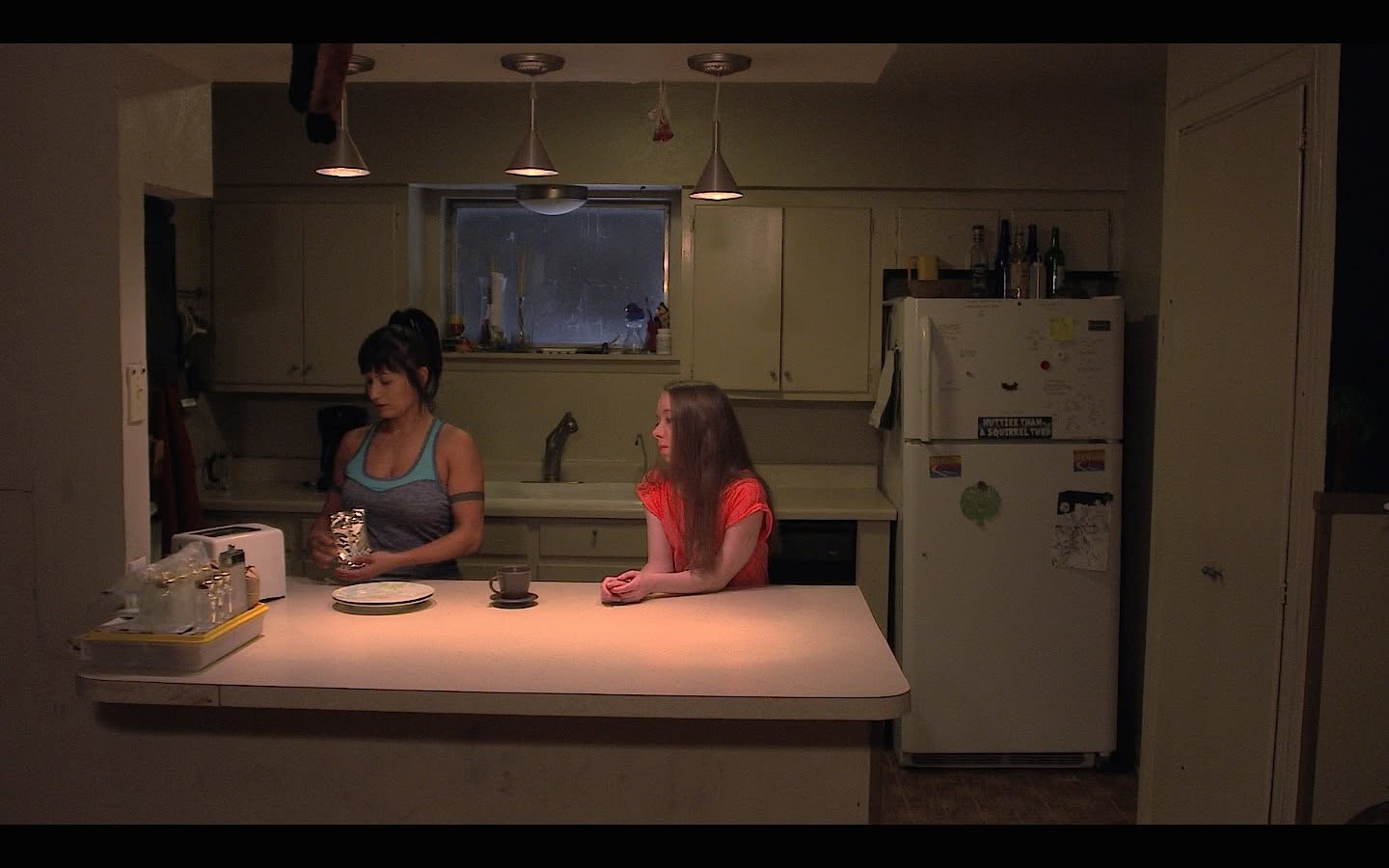 Film still in a kitchen